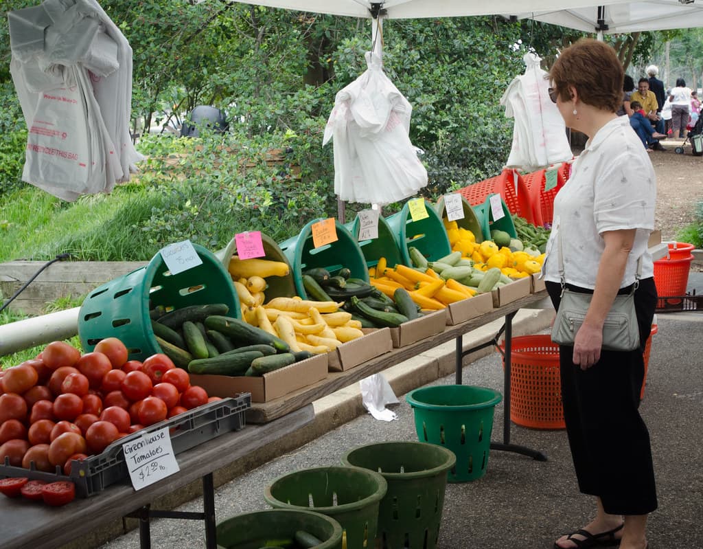 Fresh produce on display at a farmers market stall