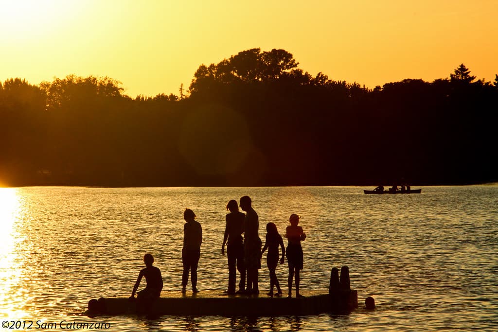 A Minneapolis city lake at the end of summer, trees along the shore