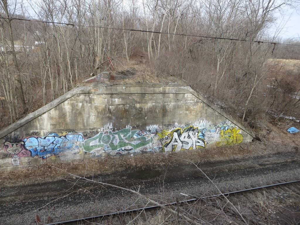 A bike trail crossing beside a light-rail line